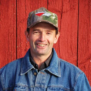 Farmer in front of barn